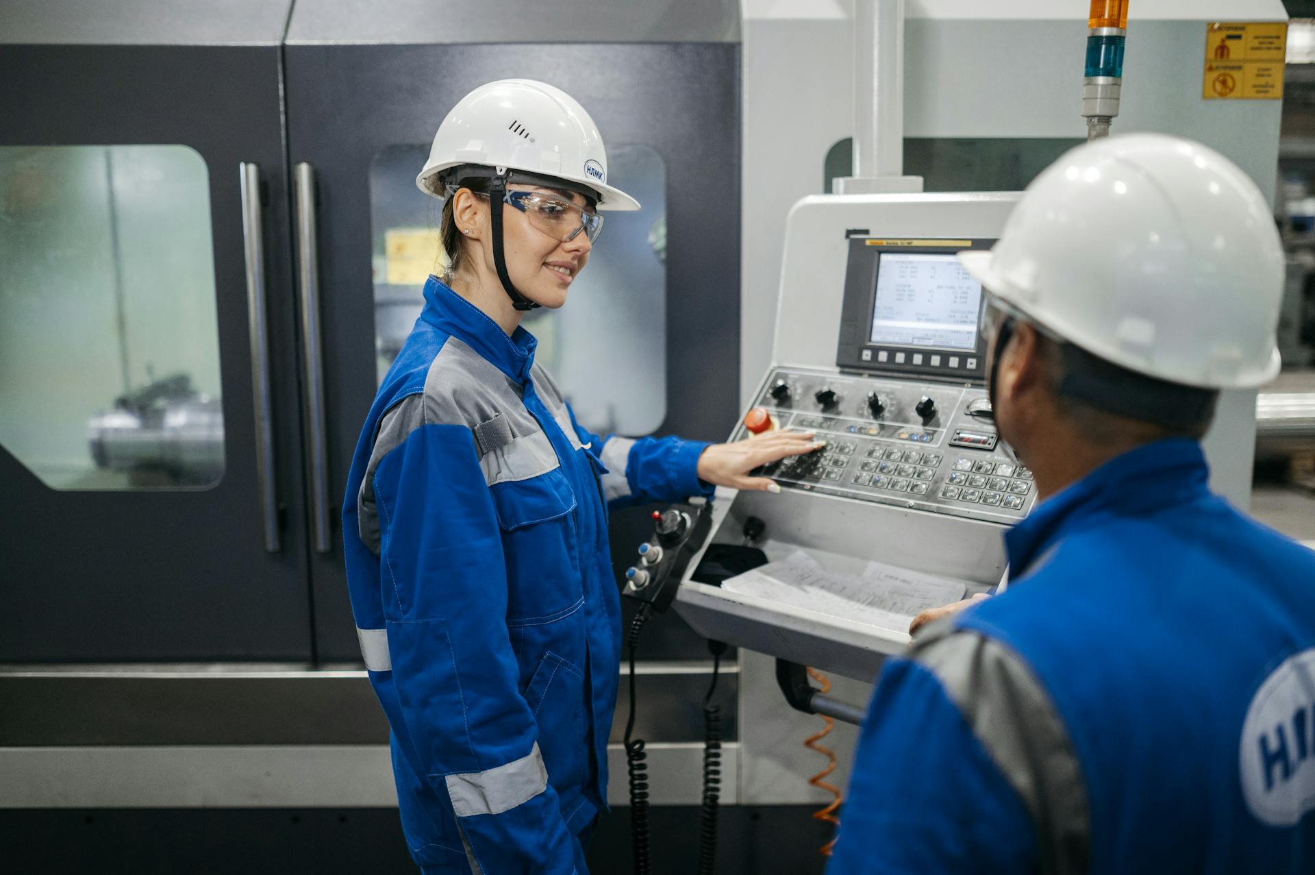 CNC machine operator with safety helmet and goggles — CCTV-GPT activity and utilisation tracking